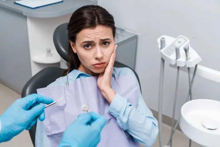 selective focus dentist latex gloves holding dental instruments upset woman - TMJ Treatment in Houston and Richmond, TX