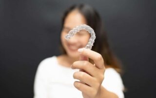 woman holding Clear Aligners