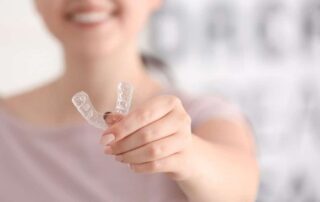 Woman holding Invisalign