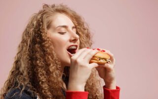 woman with braces eating food