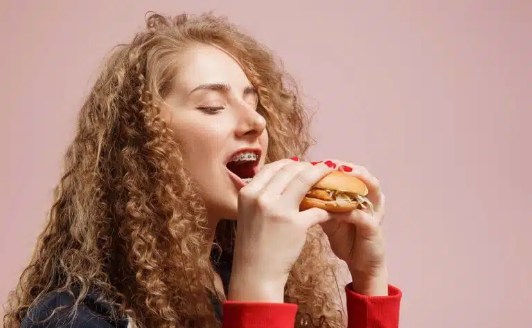 woman with braces eating food