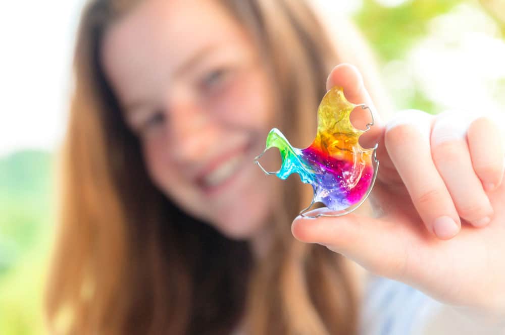 Picture of a girl holding retainer