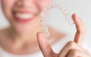 woman holding Invisalign