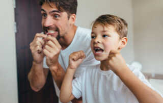 Kid Flossing with Father