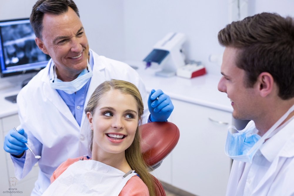 orthodontist and his assistant interacting with female patient - Mouth Breather Face in Houston and Richmond, TX 