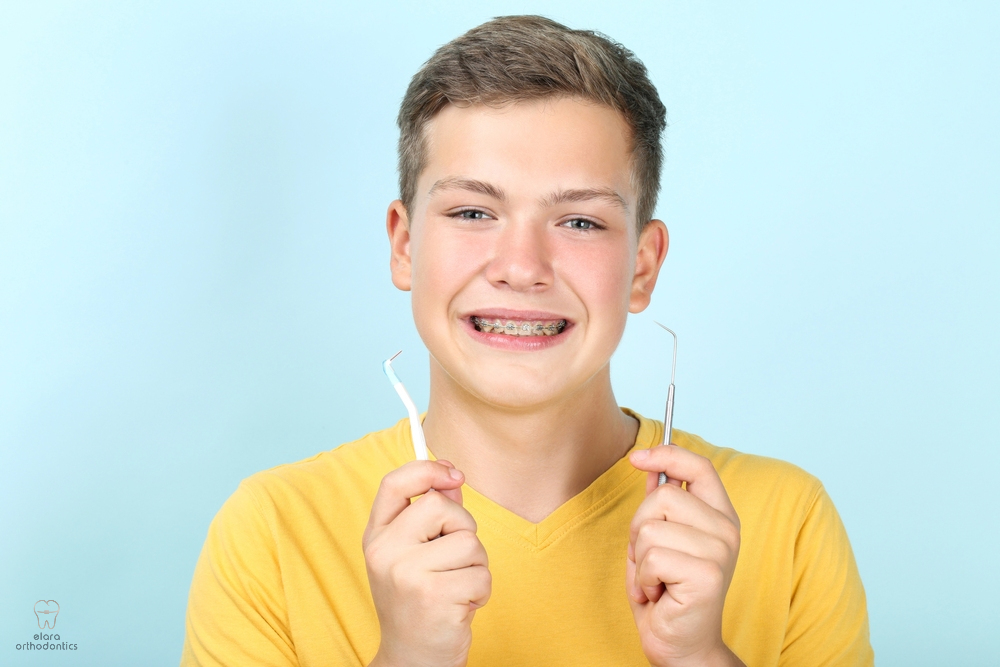 young man with metal braces toothbrush dentist tool - How to Floss with Braces in Houston and Richmond, TX. 